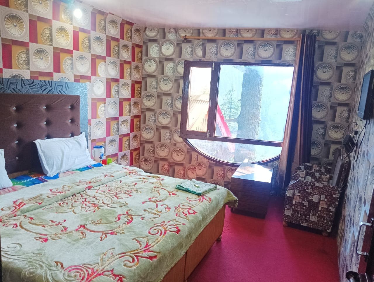Seating area of a double bed room at Karan Resort
