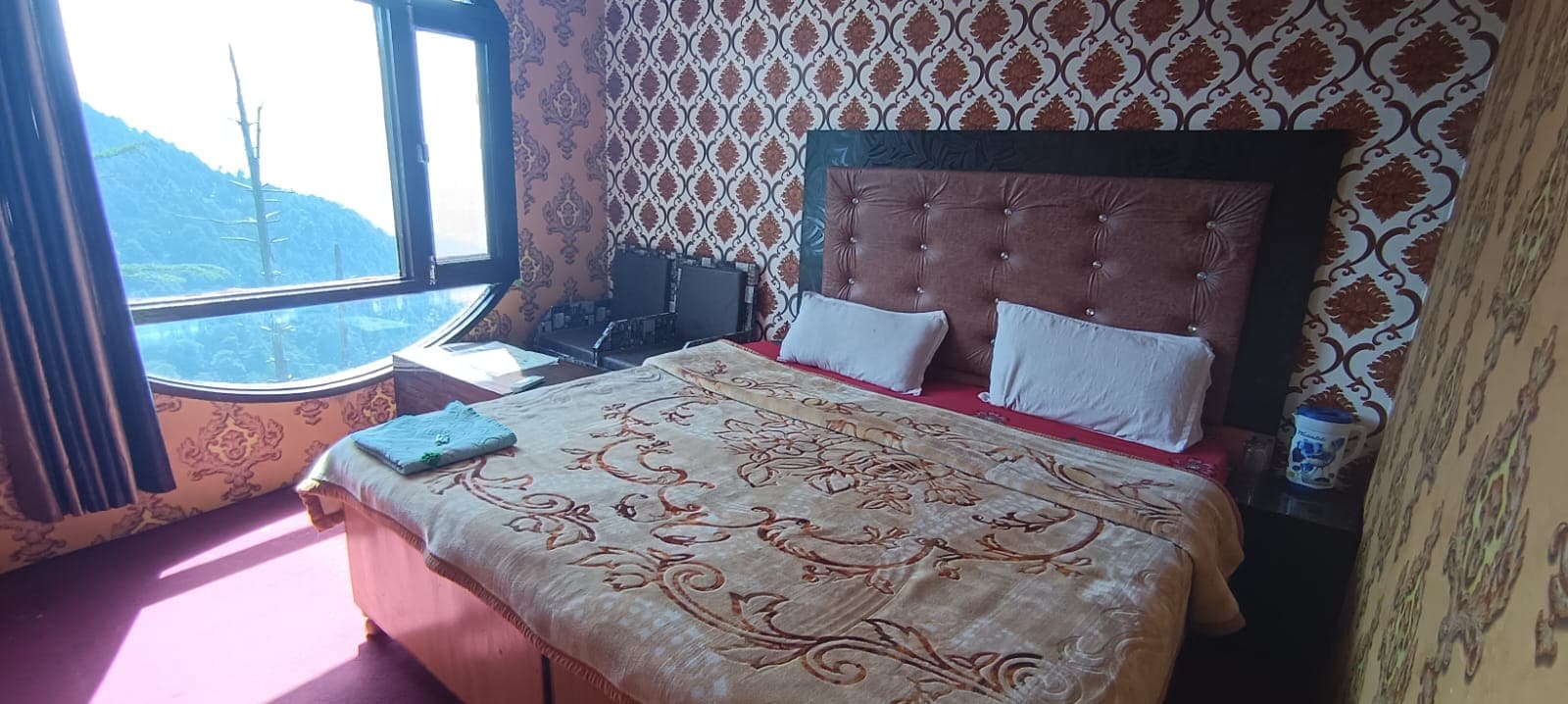 Wide view of a double bed room at Karan Resort