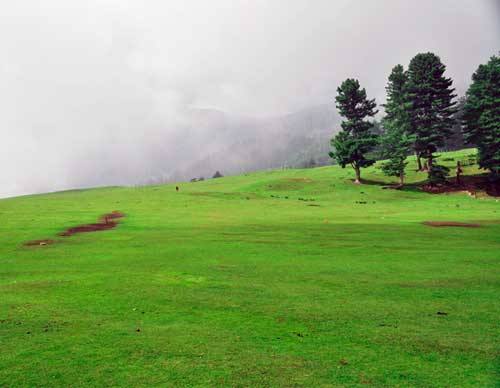 Sanasar lake ringed by lush green meadows